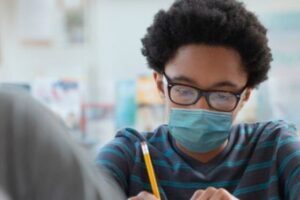 Reducing COVID-19 Transmission in Underserved Schools in North St. Louis County Through Testing and Vaccine Uptake