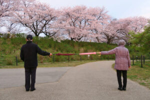 Two elderly people standing 6 feet apart